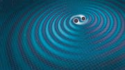 Zwei sich umkreisende schwarze Löcher erzeugen Gravitationswellen (Computersimulation). (Bild: Getty)
