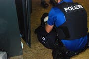 Ein Polizist bei der Kontrolle einer Tasche. (Bild: Zuger Polizei)