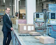 Competec-Gründer Roland Brack an einem der Fliessbänder im Hauptlager in Willisau. (Bild: Pius Amrein (25. August 2016))