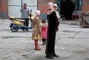 Unter Druck: Uiguren in der chinesischen Provinz Xinjiang. (Bild: Ng Han Guan/AP (Aksu, 17. Juli 2014))
