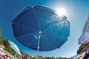 Selbst wenn der Sonnenschirm fast nichts durchlässt: UV-Strahlen haben auch im Schatten ihre Tücken. (Bild: Martin Moxter/Getty)