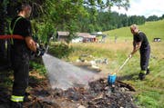 Die Feuerwehr nässt die Feuerstelle. (Bild: Kapo Schwyz)