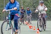Velokurs: Migrantinnen üben sich auf dem Sportplatz der Sarner Schule im Slalomfahren. (Bild: Pius Amrein)