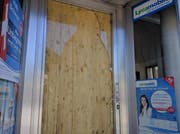 Die Ganoven hatten die Glastüre eingeschlagen. Behelfsmässig wurde am Sonntagmorgen eine Holztüre eingebaut. (Bild: Geri Holdener, Bote der Urschweiz)