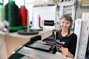 Bernadette Wiggenhauser an ihrer Mehrkopf-Stickmaschine. (Bild: Urs Bucher)