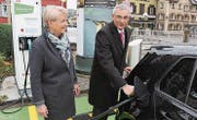 Stadträtin Gaby Krapf-Gubser und Roger Wichser von der Raiffeisenbank Gossau-Niederwil weihen die Elektrotankstelle ein. (Bild: PD)