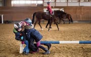 Wer gerade nicht auf dem Pferd reiten kann, stellt sich kurzerhand den Hindernisbalken als solches vor. (Bild: Michel Canonica)