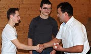 Rhodmeister Andreas Göldi gratuliert den beiden Jungbürgern Janik Egeter und Manuel Göldi zur ersten Teilnahme an einer Rhodversammlung. (Bild: Max Pflüger)