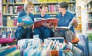 Tauschen Meinungen über Kinderbücher aus: Vereinspräsidentin Frances Bischof, flankiert von Elvira Meier (l.), Vereinsaktuarin und Bibliothekarin, und Rita Joller, Vorstandsmitglied und Bibliotheksleiterin. (Bild: Andrea Stalder)