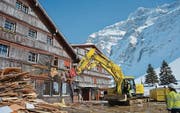 Vor dem alten Berghotel Schwägalp türmen sich Bretter. Jetzt krallen sich die Bagger die Hülle. (Bild: Roger Fuchs)