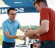 Als Dank für die gute Zusammenarbeit überreicht Simon Lumpert, Präsident von Idée Wil, Gerstenbauer Marcel Rickenmann einen Single Malt und einen Bierlikör – aus Wiler Gerste. (Bild: Yves Weibel)