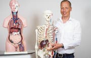 David Broeger mit Modellen der menschlichen Organe: Alles im Körper hängt zusammen. (Bild: Reto Martin)