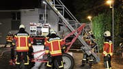 Angehörige der Feuerwehr machen die Anhängeleiter für die Personenrettung bereit. (Bild: PD)