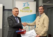 Karl Pareth, Niederlassungsleiter der Kantonalbank Buchs (links) übergibt den 500-Franken-Check an Eduard Moser, Geschäftsführer des Vereins Wohnheim Neufeld (rechts). (Bild: Alexandra Gächter)