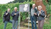 Gemeinderat Valentin Hasler, Hubertus Schmid, Hansruedi Wolfer und Doris Naef stossen auf die neue Weinweg-Tafel an. (Bild: Mario Testa)