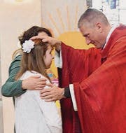 Bischofsvikar Ruedi Heim firmt eine Jugendliche. (Bild: Markus Bösch)