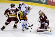 Sven Senteler, Mitte, wurde beim Spiel vom 7. März von Genfs Daniel Vukovic, links, mit dem Stock geschlagen. (Bild: KEYSTONE)