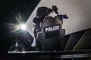 Bis an die Zähne bewaffnet und gut geschützt: Die Sondereinheit der Stadtpolizei stürmt zu Übungszwecken ein Haus. (Bild: Michel Canonica)