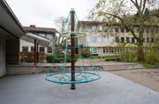 Blick vom Spielplatz in die Schulanlage Tschudiwies: Links der Eingang in die Turnhalle, hinten die beiden Gebäude mit den Schulzimmern und dazwischen der Haupteingang. (Bild: Coralie Wenger - 15. November 2014)