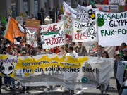 Mehr als 2000 Personen haben am Samstag in Basel gegen die "zerstörerische Macht der Agrokonzerne" protestiert. Sie fordern einen Richtungswechsel in der Landwirtschaftspolitik. (Bild: Keystone/GEORGIOS KEFALAS)