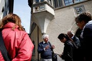 Ueli Fritsche erklärt während der Führung, warum das Genfer Wappen am Grosshaus zu finden ist. Bild: Stefan Kaiser (Zug, 19. Mai 2018)