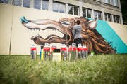 Künstler Linus von Moos bei seiner Arbeit vor der ZHB. (Bild:Queenkong/ Vero Schmid)