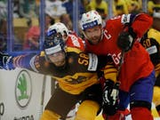 Norwegens Jonas Holös von Fribourg-Gottéron (rechts) kämpft gegen Deutschlands Markus Eisenschmid um den Puck (Bild: KEYSTONE/AP/PETR DAVID JOSEK)