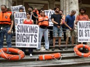 In Italien haben sich Demonstranten am Verkehrsministerium festgekettet. Sie protestieren damit gegen das Hafenverbot für Rettungsschiffe. (Bild: KEYSTONE/AP/ALESSANDRA TARANTINO)