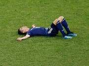 Japans Shinji Kagawa liegt nach dem Out gegen Belgien niedergeschlagen am Boden (Bild: KEYSTONE/AP/HASSAN AMMAR)