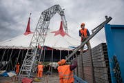 Mitarbeiter tragen Elemente der Zuschauertribüne unter das Zelt des Zirkus Knie (Bild: Corinne Glanzmann (Luzern, 5. Juli 2018))