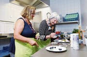 Therapeutin Silke Thomson (links) dekoriert mit Bewohnerin Verena Jolanda Schuler Muffins. (Bild: Werner Schelbert (Oberwil, 27. Juli 2018))