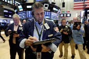 Trader William McInerney, center, works on the floor of the New York Stock Exchange, Friday, Aug. 10, 2018. Stocks are opening moderately lower on Wall Street following steeper losses in Europe, where investors worried about a sharp drop in Turkey's currency. (AP Photo/Richard Drew)