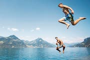 Zwei junge Männer springen in den erfrischenden Vierwaldstättersee. (Bild: Keystone/Urs Flüeler (Beckenried, 20. Juli 2018))