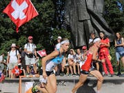   Judith Wyder in red dress on the road in Riga, fueled by Swiss supporters (Image: KEYSTONE / SWISS ORIENTING / REMY STEEGGER) 