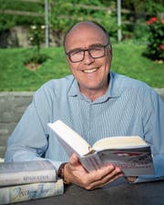 Martin Pfister zeigt die Bücher, die er zurzeit liest: «Augustus» von John Williams, Arthur Brühlmeiers «Jessy und Jim» sowie «Geschichte der Schweiz im 20. Jahrhundert» von Jakob Tanner. (Bild: Christian H. Hildebrand (Allenwinden, 12. Juli 2018))