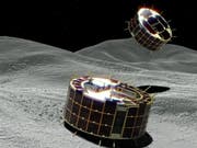 Animationsbild der beiden zylinderförmigen «Rover-1A» und «Rover-1B». (Bild: Keystone/EPA JAXA/JAXA HANDOUT)
