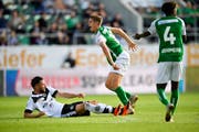 Luganos Fabio Daprelà trifft St. Gallens Cedric Itten, der danach vom Feld transportiert wird. (Bild: Keystone/Gian Ehrenzeller)