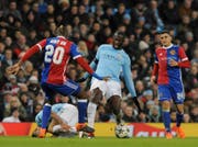 Manchester City's Yaya Toure, center, challenges for the ball with Basel's Geoffroy Serey Die, left, during the Champions League, round of 16, second leg soccer match between Manchester City and Basel at the Etihad Stadium in Manchester, England, Wednesday, March 7, 2018. (AP Photo/Rui Vieira)