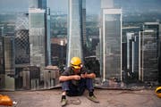 Ein chinesischer Bauarbeiter surft in einer Pause mit seinem Smartphone. (Bild: Andy Wong/AP, Peking, 19. September 2018)