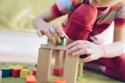 Ein Kind spielt in einer Tagesstätte mit Klötzchen. (Bild: Getty)