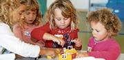 Keine zu klein, ein Lego-Fan zu sein: Die vier Mädchen bauen ein Haus für die Lego-Stadt. Bild: Andreas Taverner