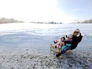 Die Beratungsstelle für Unfallverhütung (bfu) rät davon ab, mit Kleinkindern auf dem Rücken Skipisten hinunterzusausen. Schlittelplausch hält sie für die besser Alternative. (Bild: KEYSTONE/WALTER BIERI)
