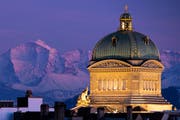 The Federal Palace pictured during the sunset with a beautiful view of the Alps, in Bern, Switzerland, Wednesday, February 13, 2019. (KEYSTONE/Anthony Anex)
