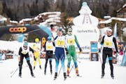 Triumphiert: Dario Cologna (Mitte) feiert den vierten Sieg beim Engadin-Skimarathon. (Bild: Ennio Leanza/Keystone (S-chanf, 10. März 2019))