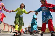 Schülerinnen auf ihren Skateboards in den Strassen der afghanischen Hauptstadt Kabul. Hier nahm der Hype seinen Anfang im Land. Bild: S. Sabawoon/ EPA (21. Juni 2011)