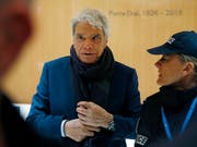 Im Prozess gegen den früheren Adidas-Eigner und Ex-Minister Bernard Tapie, hier eskortiert von einer Polizistin, fordert die Staatsanwaltschaft in Paris fünf Jahre Haft. (Bild: KEYSTONE/AP/MICHEL EULER)