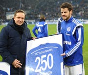 Horst Heldt, der Manager von Schalke, überreicht Barnetta ein Trikot.