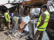 Die Polizei bei einem von dutzenden mutmasslich von Singhalesen zerstörten Läden muslimischer Besitzer in Sri Lanka. (Bild: Keystone/AP/CHAMILA KARUNARATHNE)