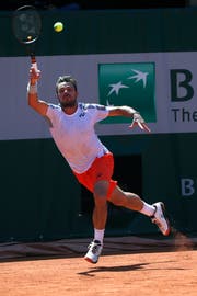 Switzerland's Stan Wawrinka plays a shot against Bulgaria's Grigor Dimitrov during their third round match of the French Open tennis tournament at the Roland Garros stadium in Paris, Saturday, June 1, 2019. (AP Photo/Pavel Golovkin)