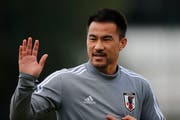 Japan's Shinji Okazaki waves to fans during a training session of the national soccer team in Sao Paulo, Brazil, Thursday, June 13, 2019. Japan will face Chile on June 17 in the Copa America soccer tournament. (AP Photo/Nelson Antoine)